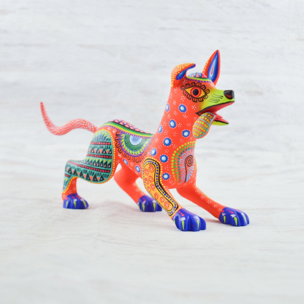 magiamexica.com-Colorful Mexican alebrije of Dante from Disney's Coco, inspired by Día de Muertos, featuring intricate designs and vibrant colors that celebrate traditional Mexican art and culture.