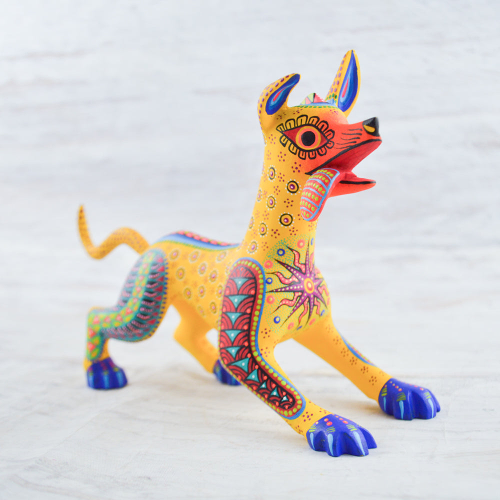 magiamexica.com-Colorful Mexican alebrije of Dante from Disney's Coco, inspired by Día de Muertos, featuring intricate designs and vibrant colors that celebrate traditional Mexican art and culture.