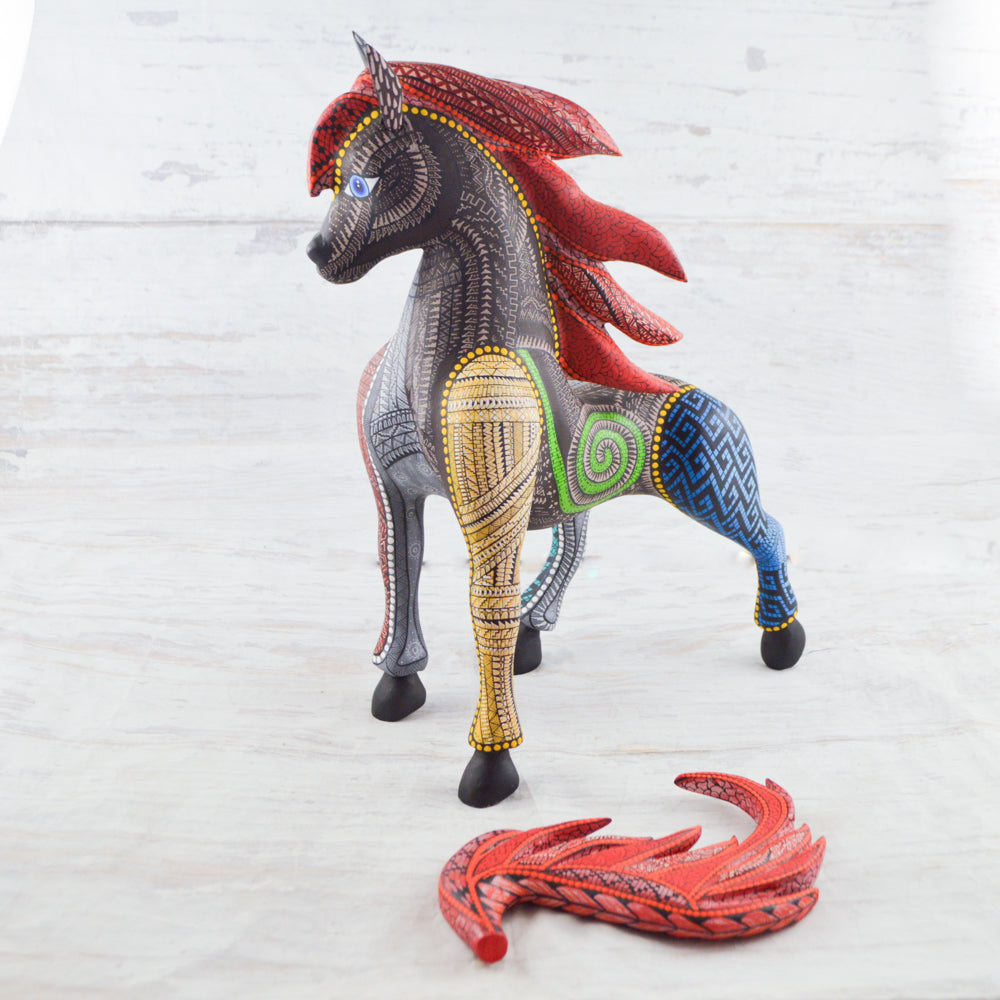 magiamexica.com - Colorful Mexican alebrije shaped like a horse, featuring intricate carvings and vibrant patterns, showcasing traditional craftsmanship and artistic detail. 