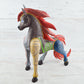 Colorful Mexican alebrije shaped like a horse, featuring intricate carvings and vibrant patterns, showcasing traditional craftsmanship and artistic detail