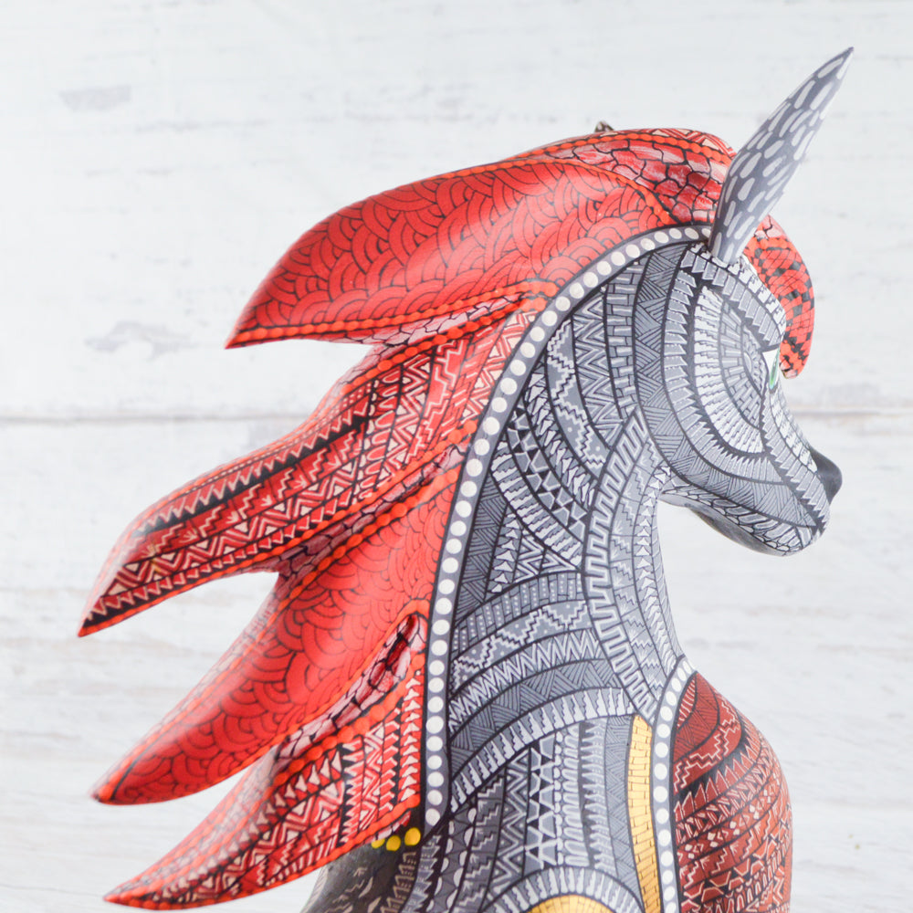 magiamexica.com - Colorful Mexican alebrije shaped like a horse, featuring intricate carvings and vibrant patterns, showcasing traditional craftsmanship and artistic detail. 