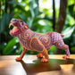 magiamexica.com - Vivid Mexican alebrije shaped like a jaguar, intricately carved and painted with bright colors and detailed patterns, reflecting traditional folk art