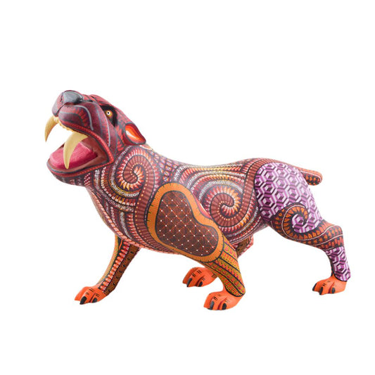 magiamexica.com - Vivid Mexican alebrije shaped like a jaguar, intricately carved and painted with bright colors and detailed patterns, reflecting traditional folk art